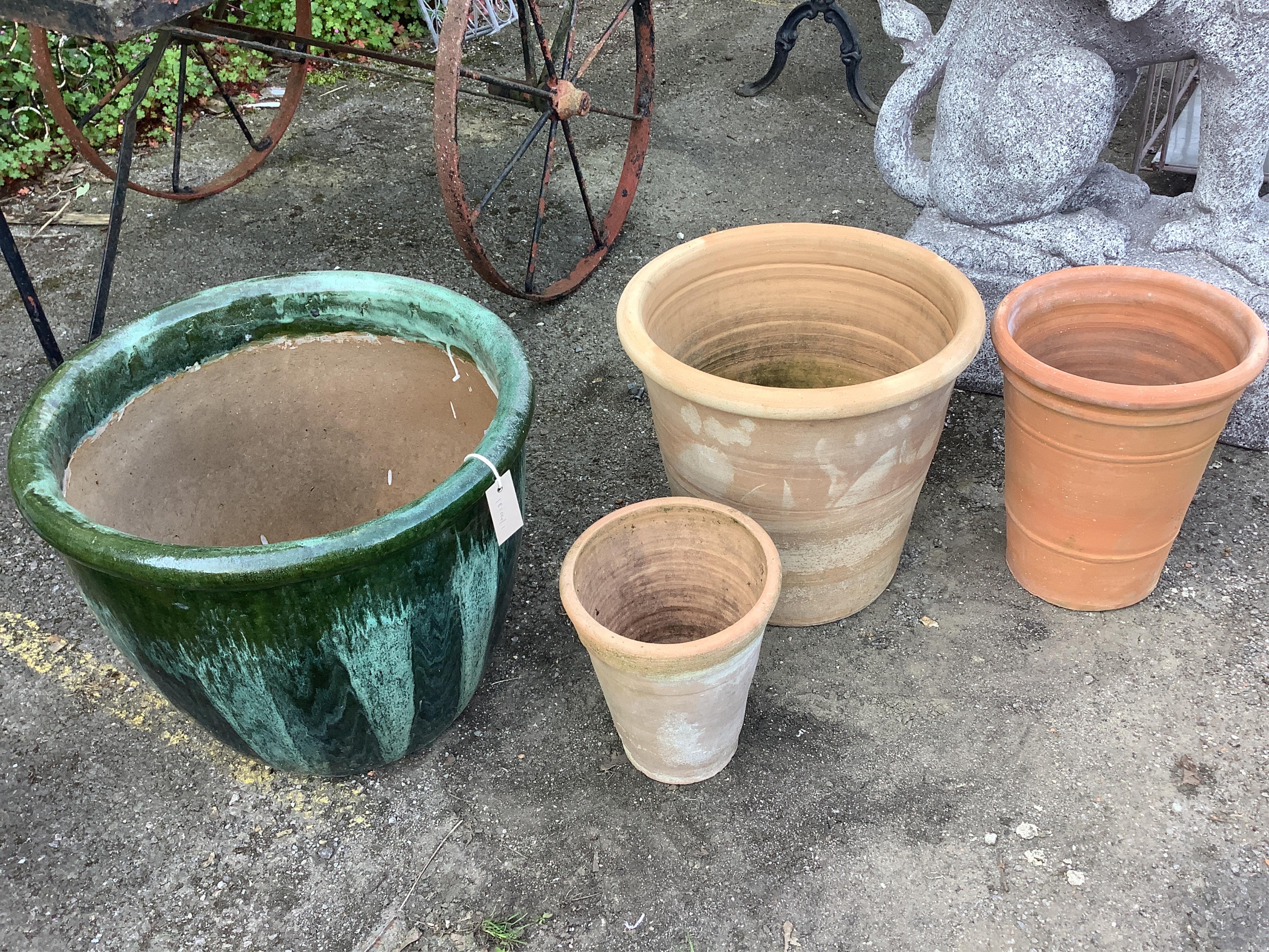 Three circular terracotta garden planters, largest diameter 49cm, height 41cm